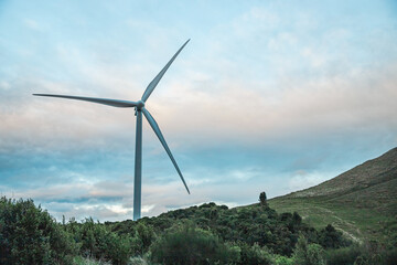 windmills on sunset sky background, alternative energy source, eco friendly electricity