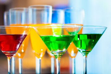 wine glass stem and colorful drinks at a party in the banquet hall.