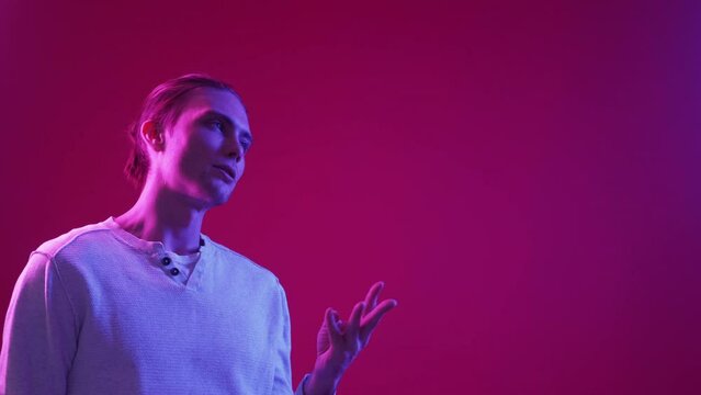 Idea consideration. Offer discussion. Dilemma solution. Neon light pensive doubtful guy finger counting pros cons isolated on magenta pink purple color gradient copy space background.