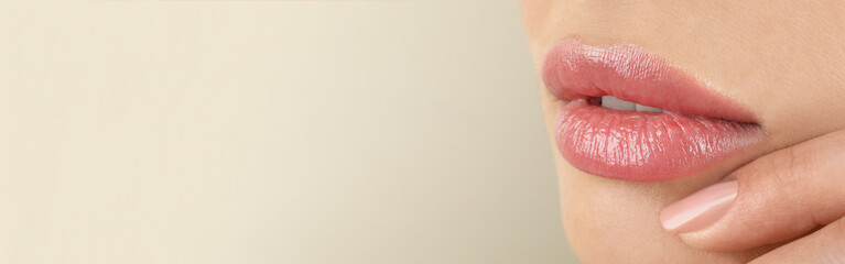 Woman with beautiful lips on light grey background, closeup view with space for text. Banner design