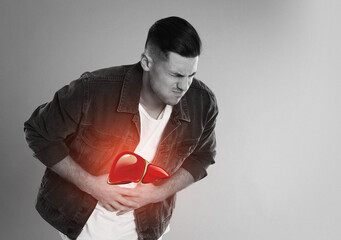 Sick man suffering from pain and illustration of unhealthy liver on light background. Hepatitis...