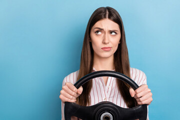 Portrait of attractive minded skeptic girl riding car thinking copy space isolated over shine blue color background - obrazy, fototapety, plakaty
