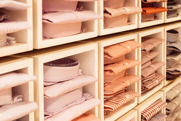 Close-up view to shelves with a lot of colorful shirts. Fashion. Style. Lifestyle. Love your life.
