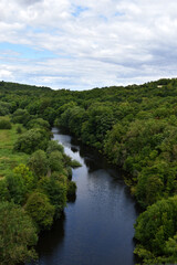 Fototapeta na wymiar Birds Eye View Over Blue River In Green Forest Woodland