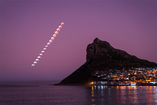 View of Super Flower Blood Moon lunar eclipse of 16 May 2022 from Hout Bay, Cape Town, Western Cape, South Africa.
