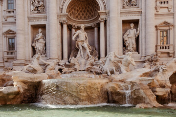 Close-up of one of the most famous landmarks in the world - Trevi Fountain in Rome in bright...