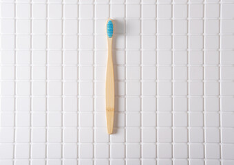 Roman numeral I composed of toothbrushes on a white tiled background