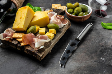 Antipasto board Platter with Spanish ham jamon serrano or Italian prosciutto crudo, Italian hard...
