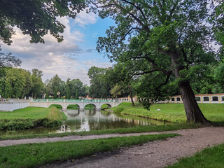 Beautiful nature, a city park and a view of the pedestrian restored medieval bridge across the river. Europe, Poland