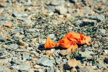 a broken orange balloon on the ground