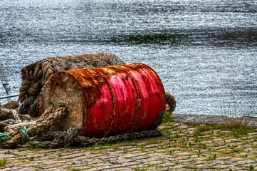nets and a red barrel on a dock
