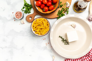 Trend Feta pasta recipe made of cherry tomatoes, feta cheese, garlic and herbs. cooking recipe ingredients, place for text, top view