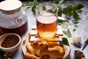 Beautiful and healthy drink of their chaga mushroom with pastries and birch branch