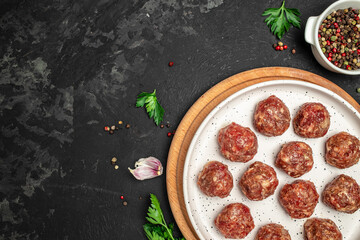 Raw meatballs minced pork meat with spices on a cutting board on a light plate, Restaurant menu, dieting, cookbook recipe top view