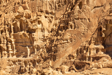 Texture and pattern of rocks in White Canyon in Sinai. Yellow and orange sandstone textured carved mountain, bright blue sky. Egyptian desert landscape. Background. Sinai peninsula, Egypt