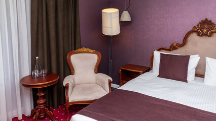 Interior of hotel Luxury room, bed. chair, table.