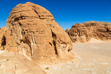 White Canyon in Sinai. Yellow and orange sandstone textured carved mountain, bright blue sky. Egyptian desert landscape. Sinai peninsula, Egypt