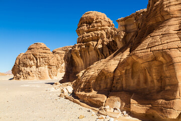 White Canyon in Sinai. Yellow and orange sandstone textured carved mountain, bright blue sky. Egyptian desert landscape. Sinai peninsula, Egypt