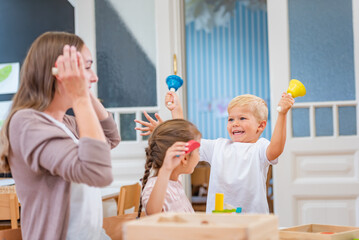 Noisy child at kindergarten. How to control a noisy kindergarten class - obrazy, fototapety, plakaty