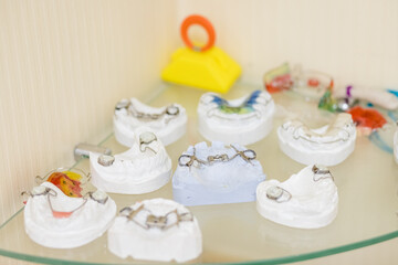 models of Dental plate to align deformed teeth. unremovable orthodontic plate on a dental model of...