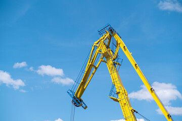 Yellow crane against blue sky