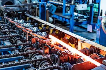 Machine for induction heating of metal. A metal rod heated in an induction furnace. Hot metal...