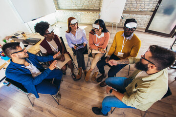 Fototapeta premium Team building. Happy colleagues playing who I am game, having great pastime together