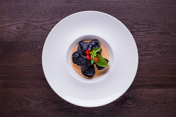 Black ravioli with pepper, caviar