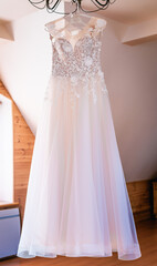 Fototapeta na wymiar White wedding dress hanging front shot