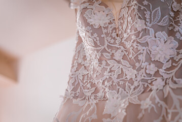 White wedding dress hanging close up shot