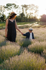 Mom and son on a lavender field during sunset