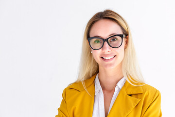 Portrait of a successful confident blonde business woman in eyeglasses and yellow jacket on white...