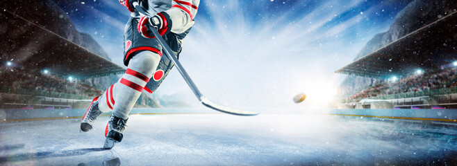 Close up of ice hockey stick on ice rink in position to hit hockey puck. © 103tnn