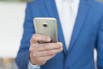 Detail of a businessman using her cellphone