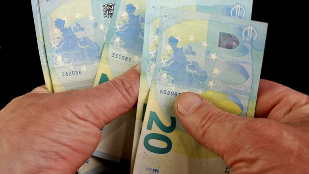Hands counting stack cash twenty euro bills, recalculation banknotes.