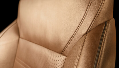 Modern luxury orange leather interior. Part of brown leather car seat details with stitching....