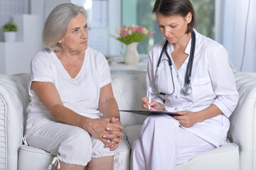 Sick senior woman with caring doctor