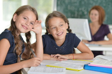 Beautiful  girls studying at the desk in class room