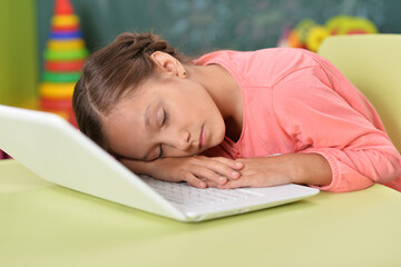 beautiful young girl sleeping on laptop
