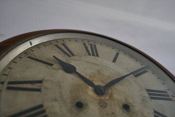 Details of an old clock on white wall