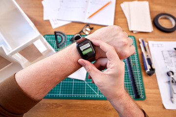 POV Shot Of Male Architect Working In Office Using Smart Watch