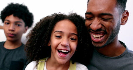 Siblings love care and affection. Older brother kissing little sister on cheek, mixed race ethnicity