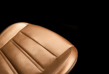 Modern luxury orange leather interior. Part of brown leather car seat details with stitching....