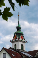 Fototapeta na wymiar The bell tower of the Kussnacht am Rigi church in the canton of Schwyz, Switzerland