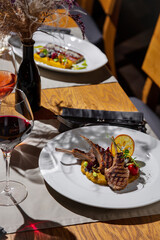 Fried meat on the bone with tomatoes, pea sprouts, lime, mung bean salad and mashed potatoes