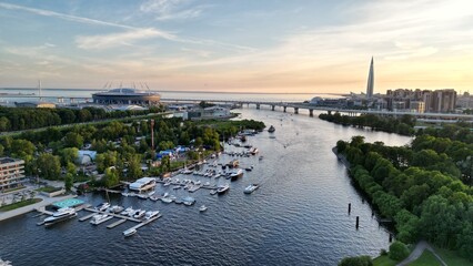 Fototapeta premium Sunset, river and skyscraper. Drone Photo. 2022