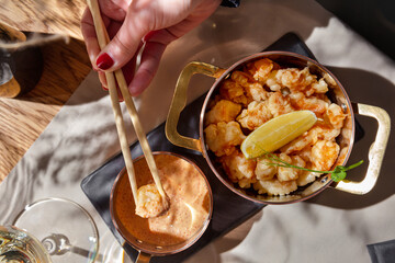Fried shrimp in batter with lemon, pea sprouts