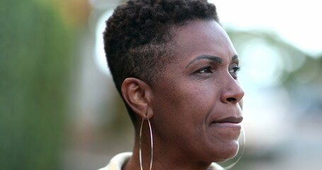 Pensive African woman thinking. Contemplative black lady in deep think outside