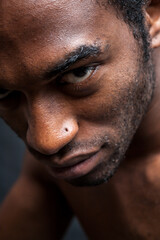 Capoeira artist. A handsome young black male model looking confidently into the camera; from a series of images with the same model.