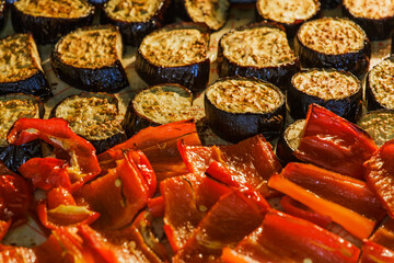 The concept of cooking, cooking. A baking dish with vegetables in the oven in the home kitchen. Baked vegetables in the oven pepper and eggplant selective focus. Food.